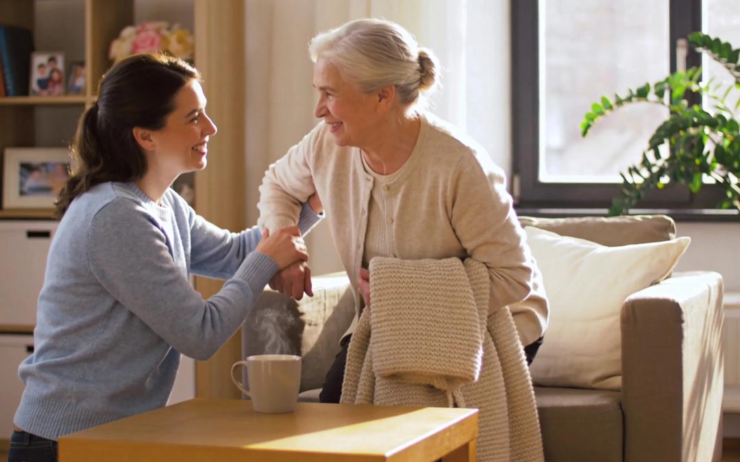 Woman assisting senior with in-home care and support, senior care franchise opportunities.